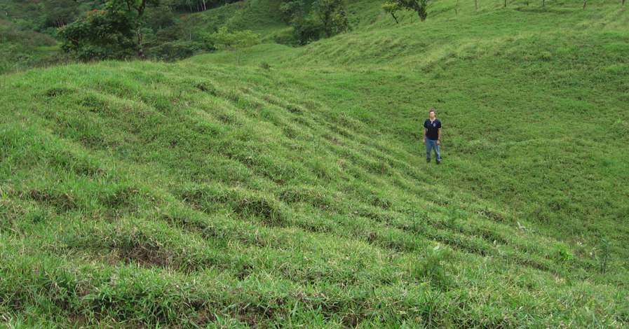 Tim Huth at bottom of hill rutted by cows in Costa Rica
